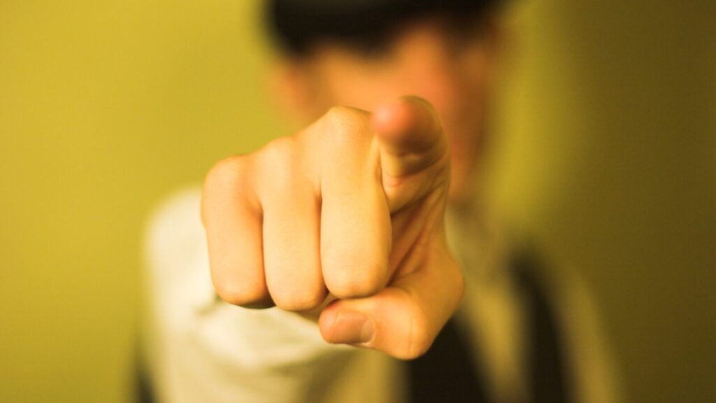 A man pointing his finger directly at the camera.