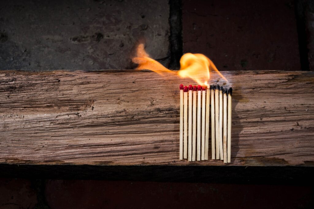Matches burning on a piece of wood